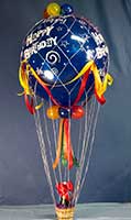 Giant Blue hot-air style happy birthday balloon with a basket with champagne or sparkling cider