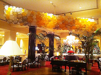 a net balloon drop of black and white balloons rigged over the dance floor in lobby of the San Jose Fairmont Hotel