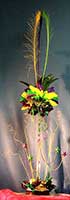 This 24 inch tall centerpiece created from feathers and Mylar® accents in lime green, purple, and yellow communicates a carnival theme appearance