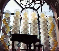 Columns serving as a background for a grand piano for a formal event at the San Jose Fairmont Hotel